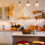 Kitchen decorated with lights, garland and pumpkins for the holidays